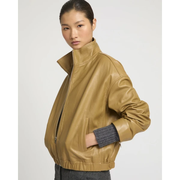 Woman wearing Yves Salomon shearling fur coat – luxury outerwear at Coveti