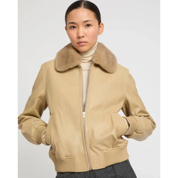 Woman wearing Yves Salomon shearling fur coat – luxury outerwear at Coveti