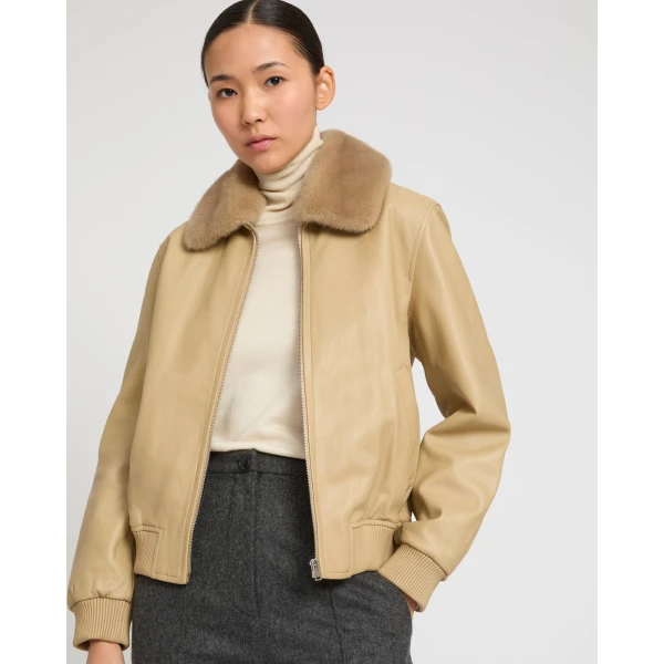 Woman wearing Yves Salomon shearling fur coat – luxury outerwear at Coveti