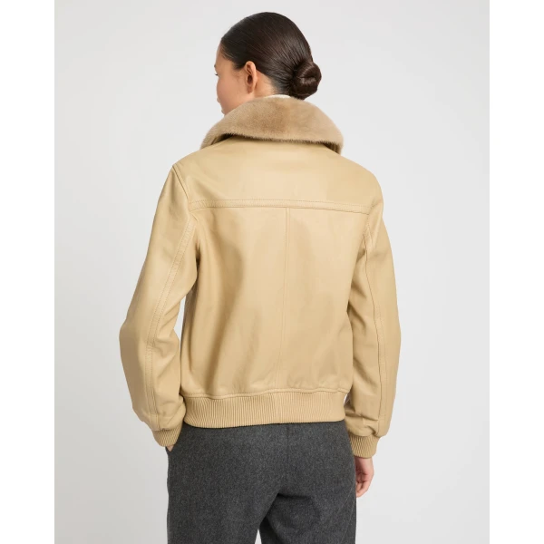 Woman wearing Yves Salomon shearling fur coat – luxury outerwear at Coveti