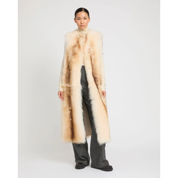 Woman wearing Yves Salomon shearling fur coat – luxury outerwear at Coveti
