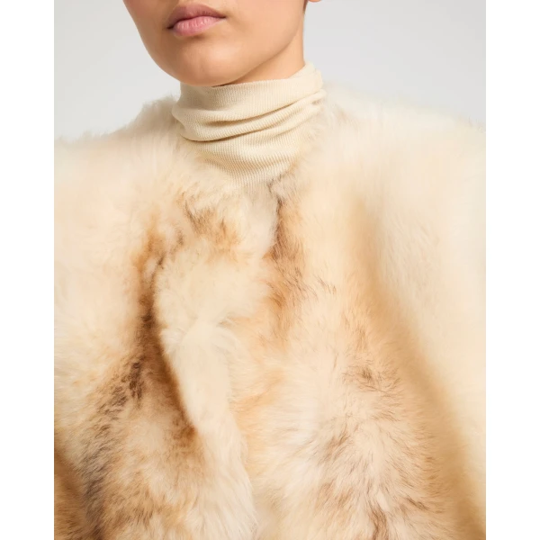 Woman wearing Yves Salomon shearling fur coat – luxury outerwear at Coveti
