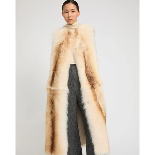 Woman wearing Yves Salomon shearling fur coat – luxury outerwear at Coveti