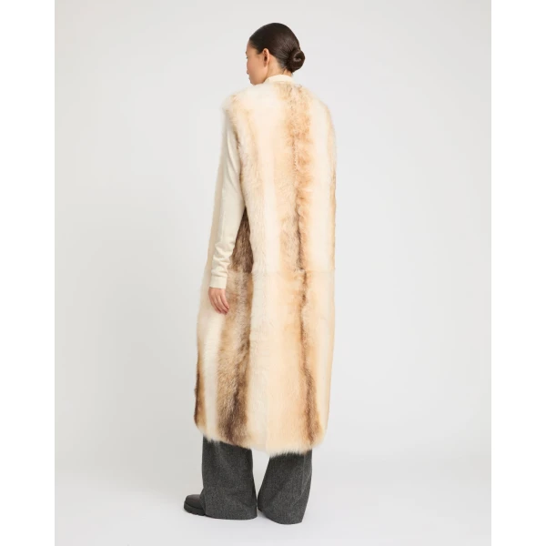 Woman wearing Yves Salomon shearling fur coat – luxury outerwear at Coveti