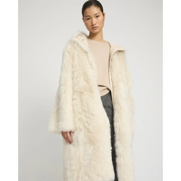 Woman wearing Yves Salomon shearling fur coat – luxury outerwear at Coveti