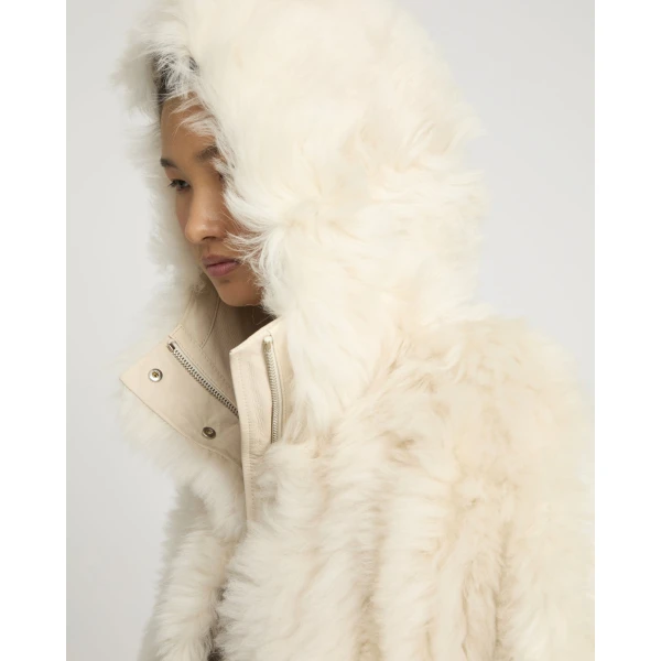 Woman wearing Yves Salomon shearling fur coat – luxury outerwear at Coveti