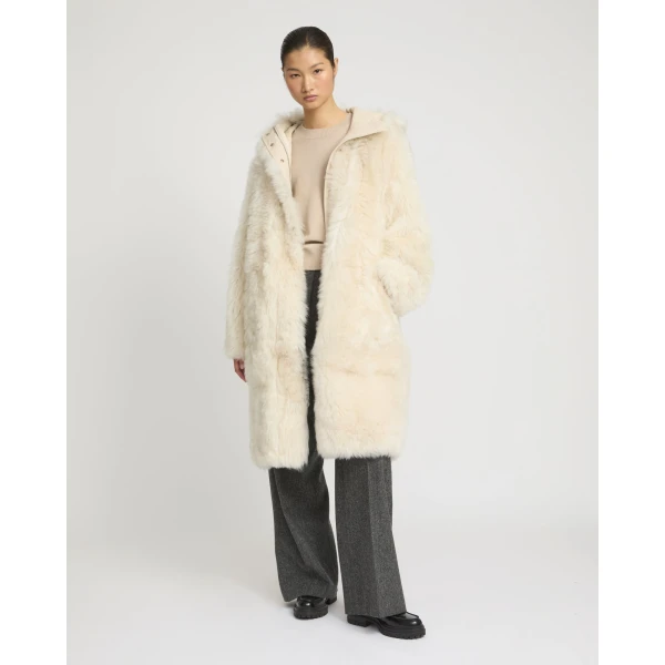 Woman wearing Yves Salomon shearling fur coat – luxury outerwear at Coveti