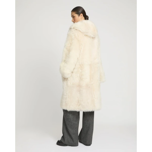 Woman wearing Yves Salomon shearling fur coat – luxury outerwear at Coveti