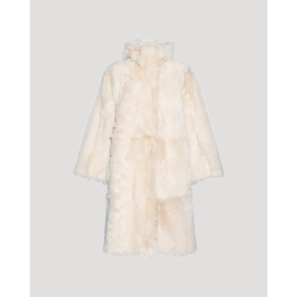 Woman wearing Yves Salomon shearling fur coat – luxury outerwear at Coveti