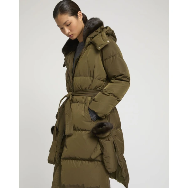 Woman wearing Yves Salomon shearling fur coat – luxury outerwear at Coveti