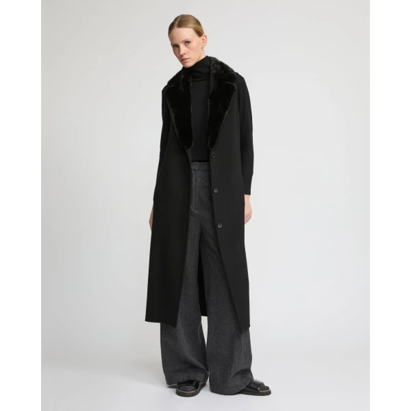 Woman wearing Yves Salomon shearling fur coat – luxury outerwear at Coveti