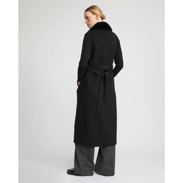 Woman wearing Yves Salomon shearling fur coat – luxury outerwear at Coveti