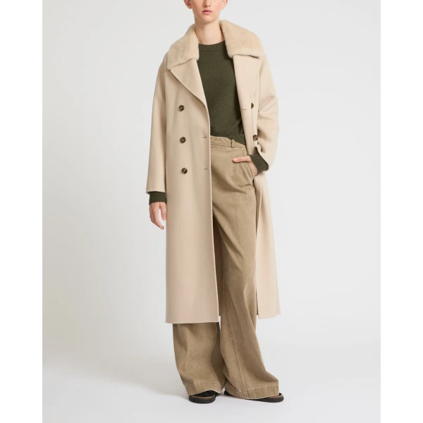 Woman wearing Yves Salomon shearling fur coat – luxury outerwear at Coveti