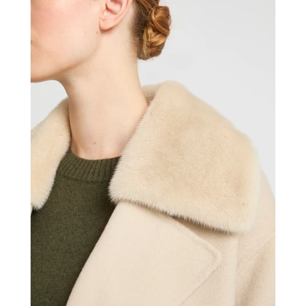 Woman wearing Yves Salomon shearling fur coat – luxury outerwear at Coveti