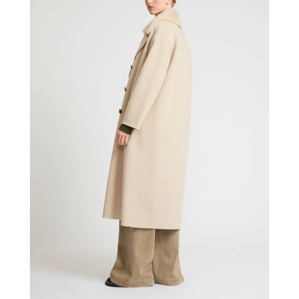Woman wearing Yves Salomon shearling fur coat – luxury outerwear at Coveti