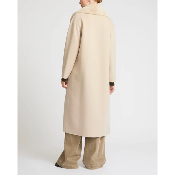 Woman wearing Yves Salomon shearling fur coat – luxury outerwear at Coveti