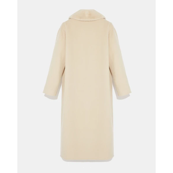 Woman wearing Yves Salomon shearling fur coat – luxury outerwear at Coveti