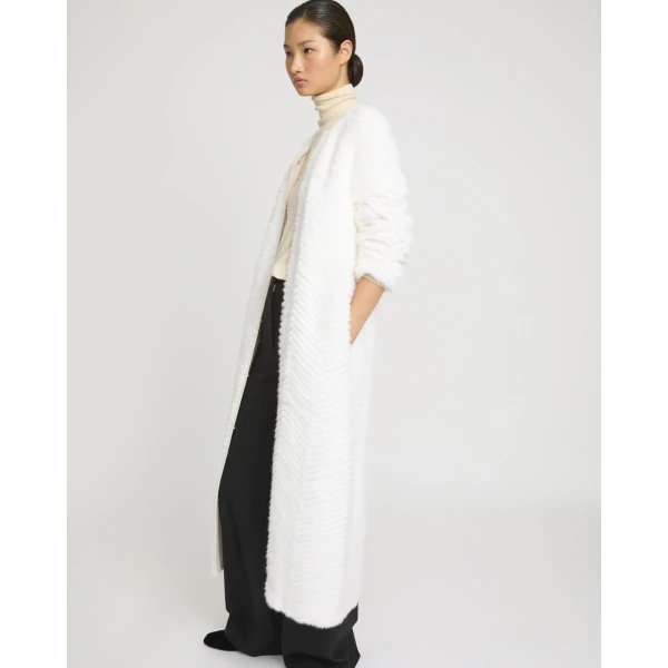Woman wearing Yves Salomon shearling fur coat – luxury outerwear at Coveti