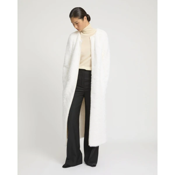 Woman wearing Yves Salomon shearling fur coat – luxury outerwear at Coveti