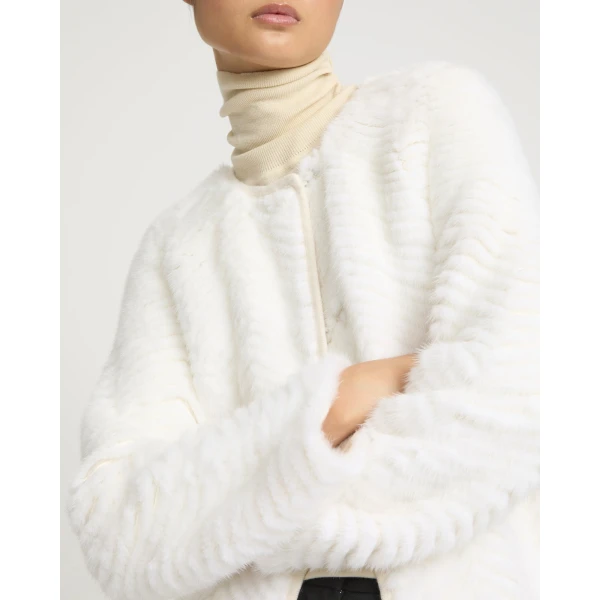 Woman wearing Yves Salomon shearling fur coat – luxury outerwear at Coveti