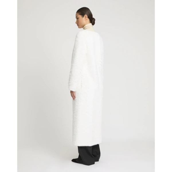 Woman wearing Yves Salomon shearling fur coat – luxury outerwear at Coveti