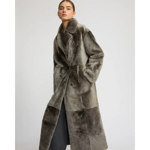 Woman wearing Yves Salomon shearling fur coat – luxury outerwear at Coveti