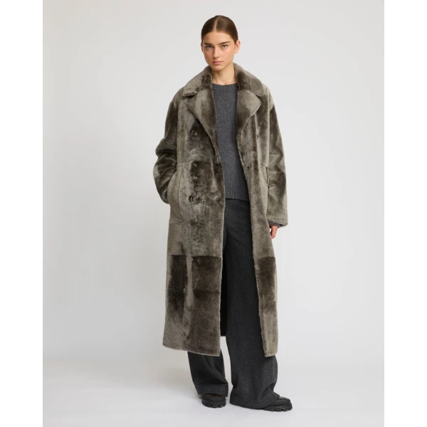 Woman wearing Yves Salomon shearling fur coat – luxury outerwear at Coveti