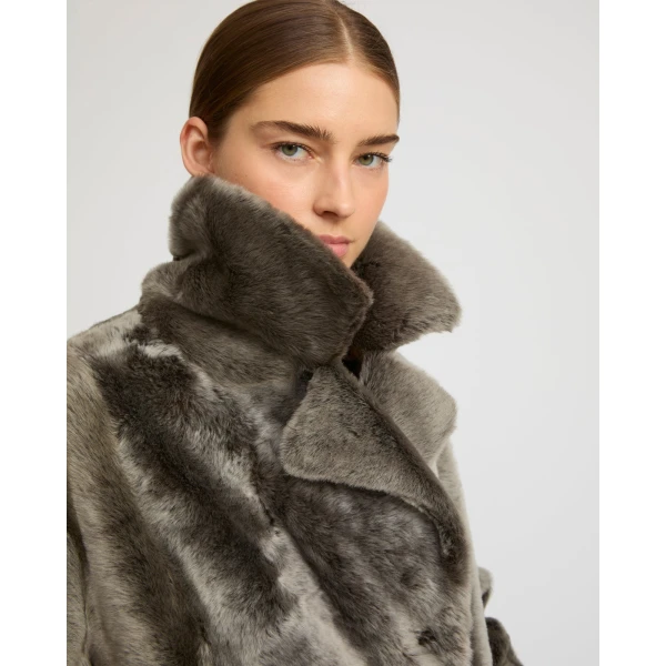 Woman wearing Yves Salomon shearling fur coat – luxury outerwear at Coveti