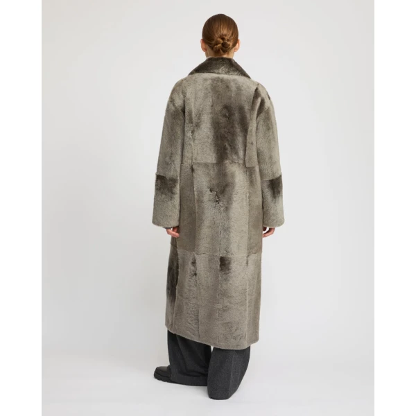 Woman wearing Yves Salomon shearling fur coat – luxury outerwear at Coveti