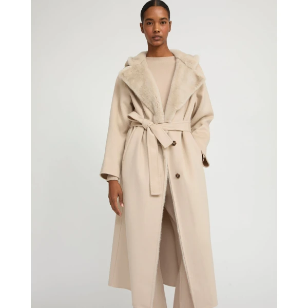 Woman wearing Yves Salomon shearling fur coat – luxury outerwear at Coveti