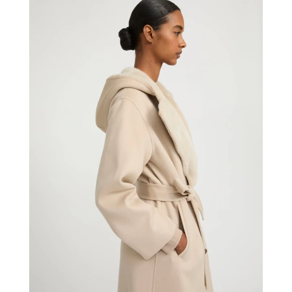 Woman wearing Yves Salomon shearling fur coat – luxury outerwear at Coveti