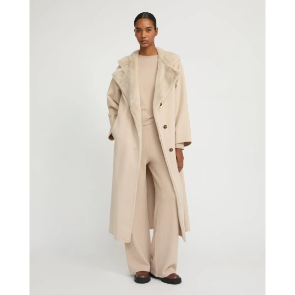 Woman wearing Yves Salomon shearling fur coat – luxury outerwear at Coveti