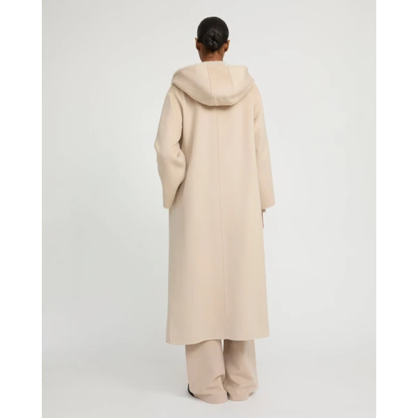 Woman wearing Yves Salomon shearling fur coat – luxury outerwear at Coveti