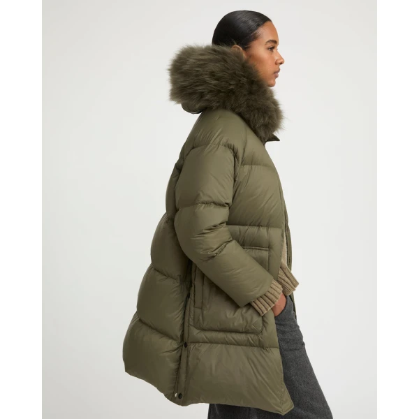 Woman wearing Yves Salomon shearling fur coat – luxury outerwear at Coveti