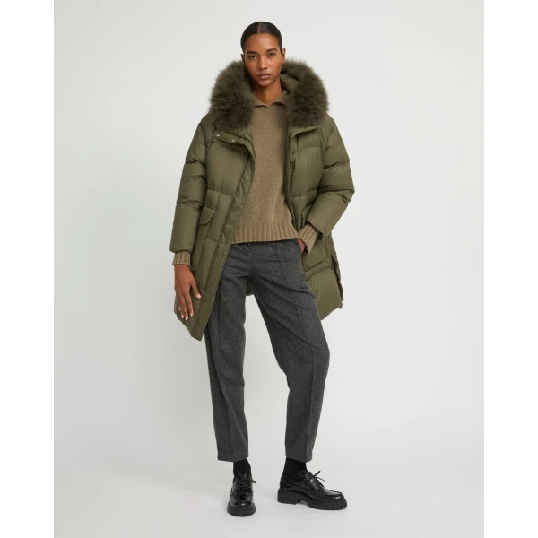 Woman wearing Yves Salomon shearling fur coat – luxury outerwear at Coveti