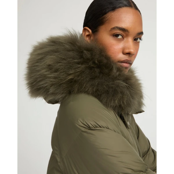 Woman wearing Yves Salomon shearling fur coat – luxury outerwear at Coveti
