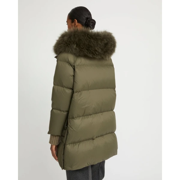 Woman wearing Yves Salomon shearling fur coat – luxury outerwear at Coveti