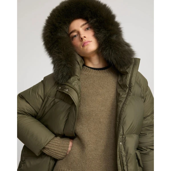 Woman wearing Yves Salomon shearling fur coat – luxury outerwear at Coveti