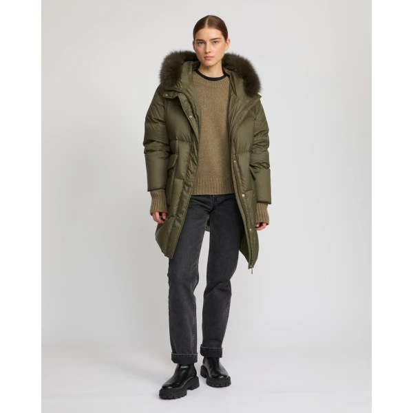 Woman wearing Yves Salomon shearling fur coat – luxury outerwear at Coveti
