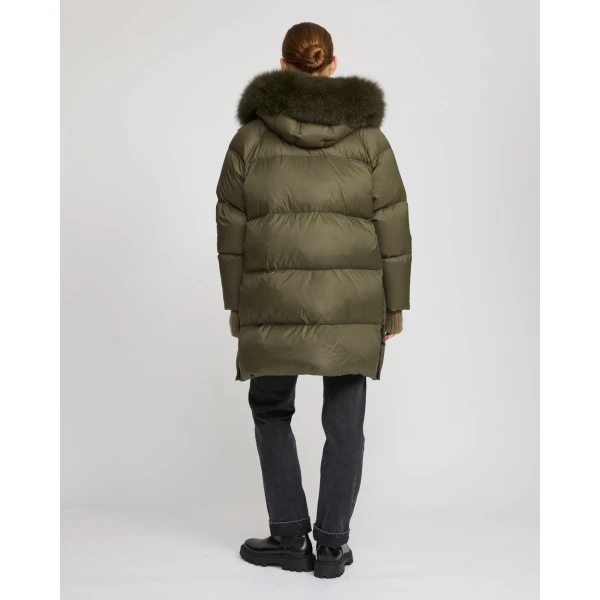 Woman wearing Yves Salomon shearling fur coat – luxury outerwear at Coveti