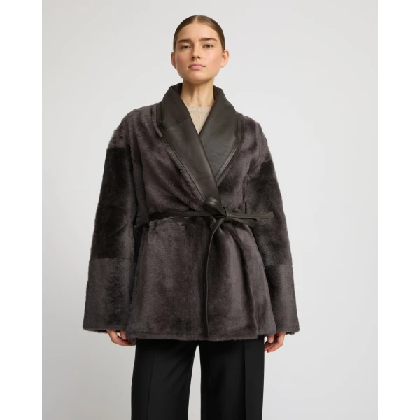 Woman wearing Yves Salomon shearling fur coat – luxury outerwear at Coveti