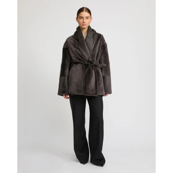 Woman wearing Yves Salomon shearling fur coat – luxury outerwear at Coveti