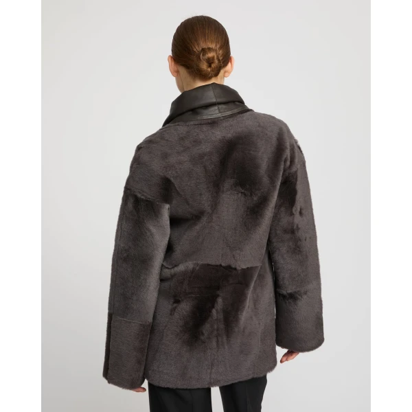 Woman wearing Yves Salomon shearling fur coat – luxury outerwear at Coveti