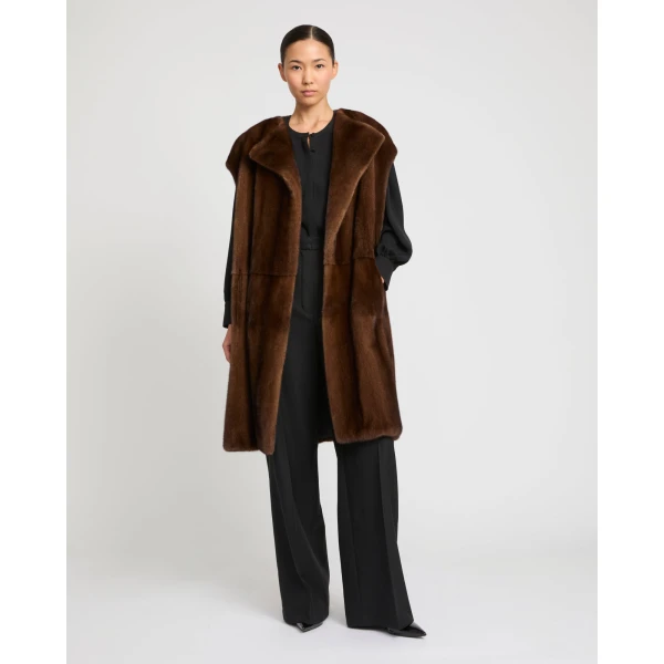 Woman wearing Yves Salomon shearling fur coat – luxury outerwear at Coveti