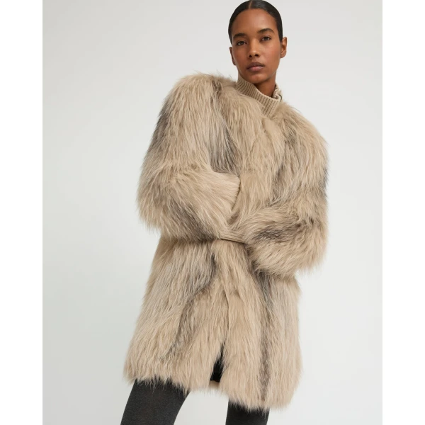 Woman wearing Yves Salomon shearling fur coat – luxury outerwear at Coveti