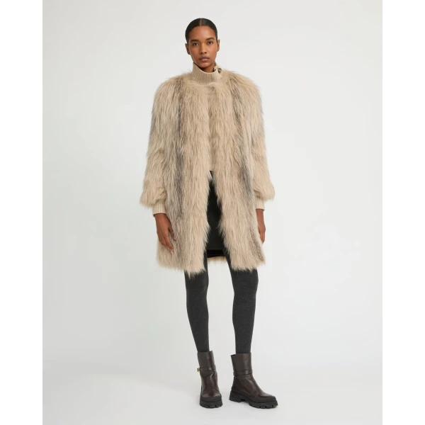 Woman wearing Yves Salomon shearling fur coat – luxury outerwear at Coveti