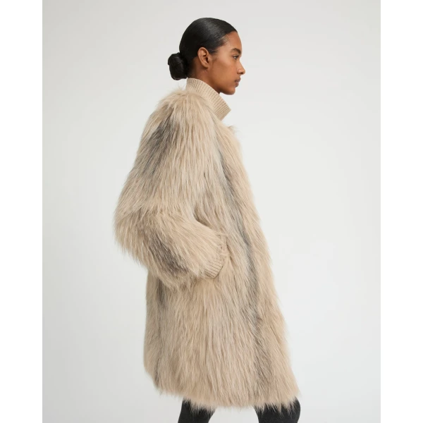 Woman wearing Yves Salomon shearling fur coat – luxury outerwear at Coveti