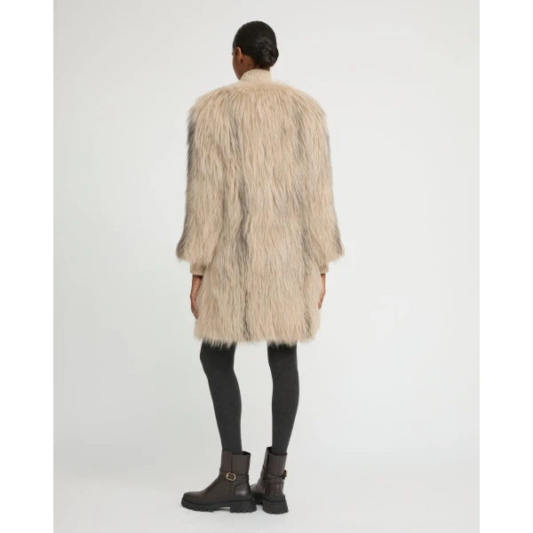Woman wearing Yves Salomon shearling fur coat – luxury outerwear at Coveti