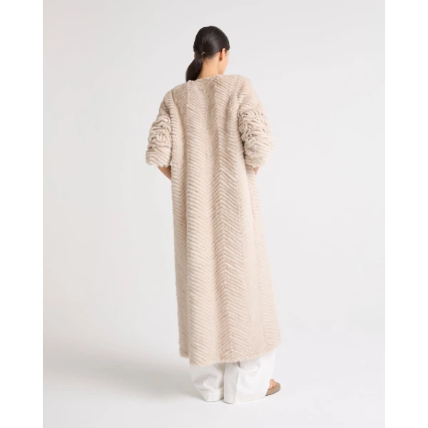 Woman wearing Yves Salomon shearling fur coat – luxury outerwear at Coveti