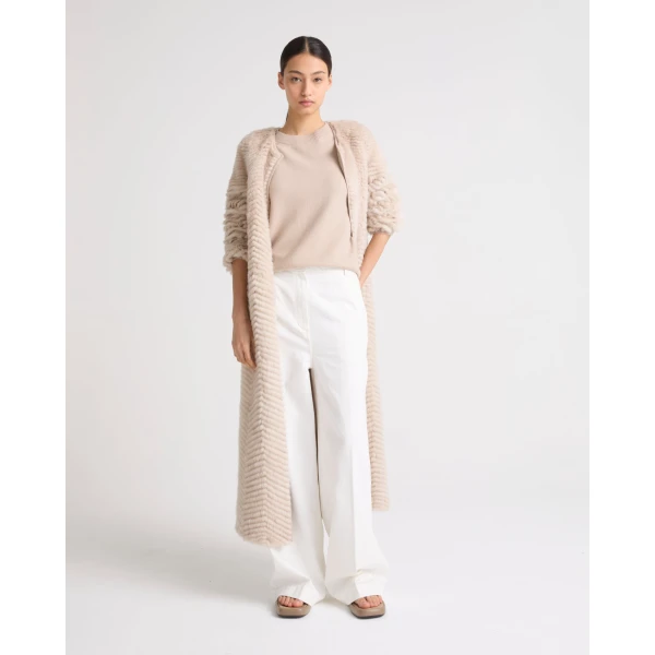 Woman wearing Yves Salomon shearling fur coat – luxury outerwear at Coveti